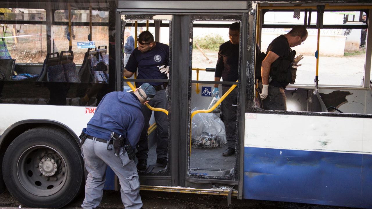 Police officers inspect the scene of an explosion inside a bus on December 22 in Israel.