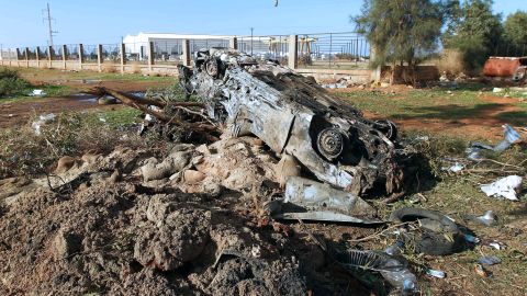 A burnt-out vehicle is seen at the scene of a suicide bomber attack on December 22 outside Benghazi.
