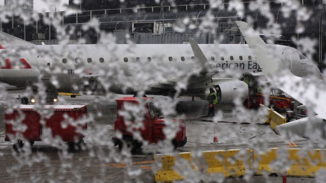 An American Eagle plane waits to be de-iced at Chicago's O'Hare International Airport on Sunday, December 22. The Midwest was battling snowstorms and the South flooding over the weekend, while the Mid-Atlantic states experienced record highs. More extreme weather is expected during the holiday week.