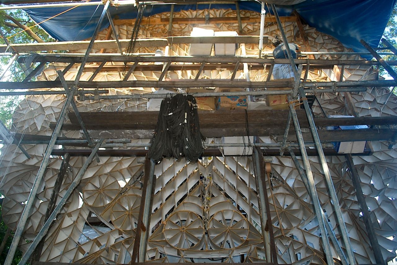 A worker configures bulbs in the honeycomb-like frame of a 16-foot parol at the workshop of the doyen of San Fernando's parols - Ernesto 'Erning' David Quiwa.