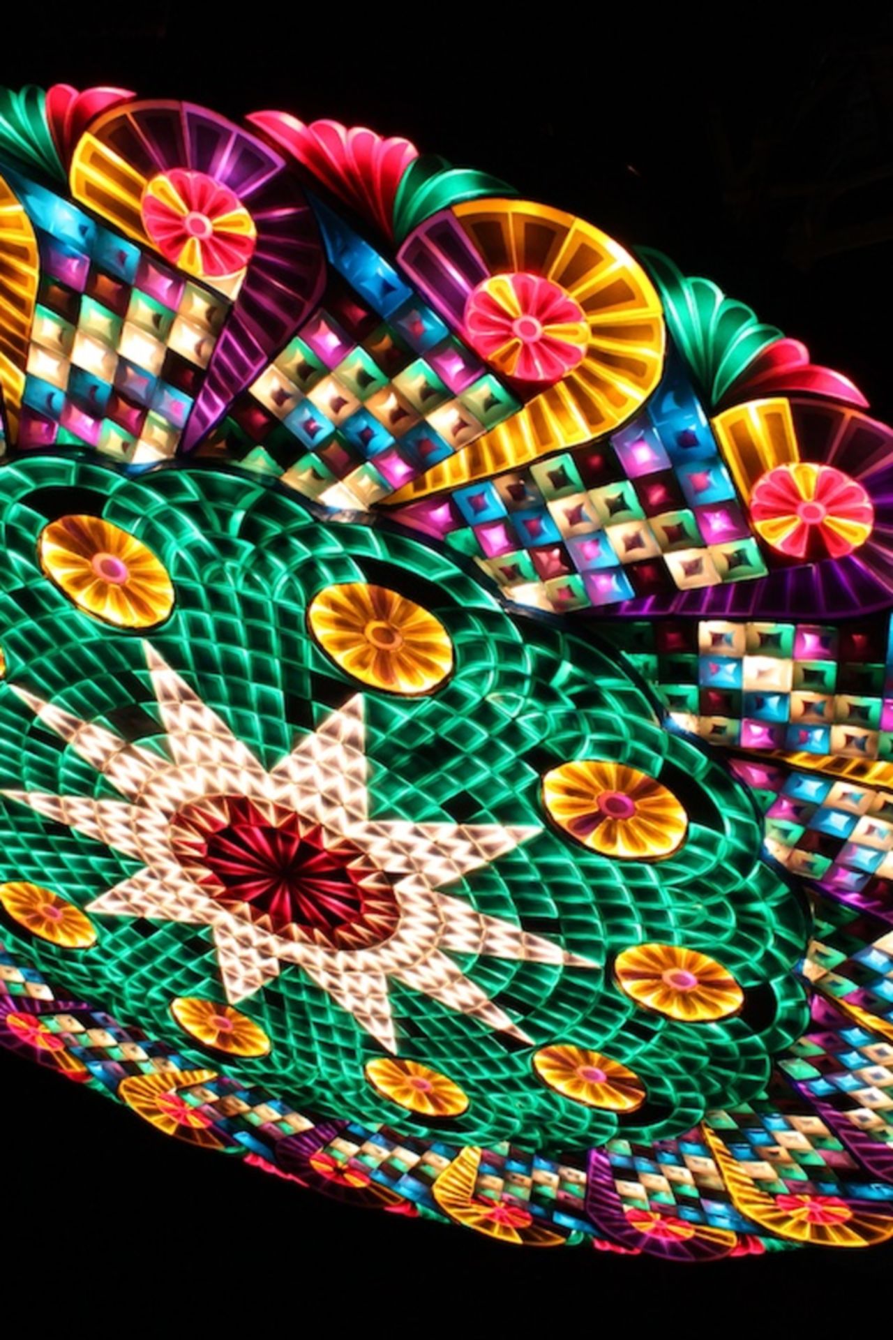 A finished giant Christmas parol lights up the night sky at the annual Christmas festival in San Fernando. Polyvinyl plastic in a hodgepodge of colors usually covers a giant parol. 