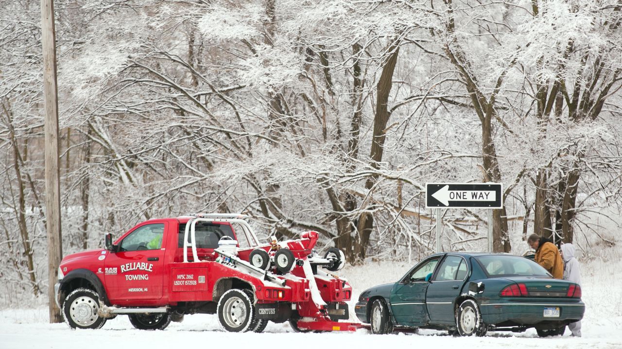 A tow truck prepares to pull a vehicle from a crash scene in Muskegon, Michigan, on December 22.
