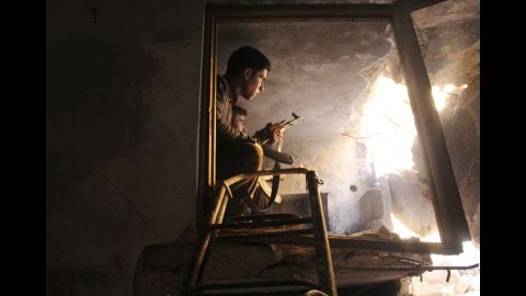 Free Syrian Army fighters sit in a damaged house in Old Aleppo on Saturday, December 21. 