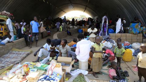 Families seek refuge in U.N. camp warehouse on December 23.