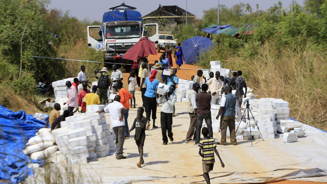 People gather to receive emergency food rations from the World Food Programme at a makeshift camp on December 23. 