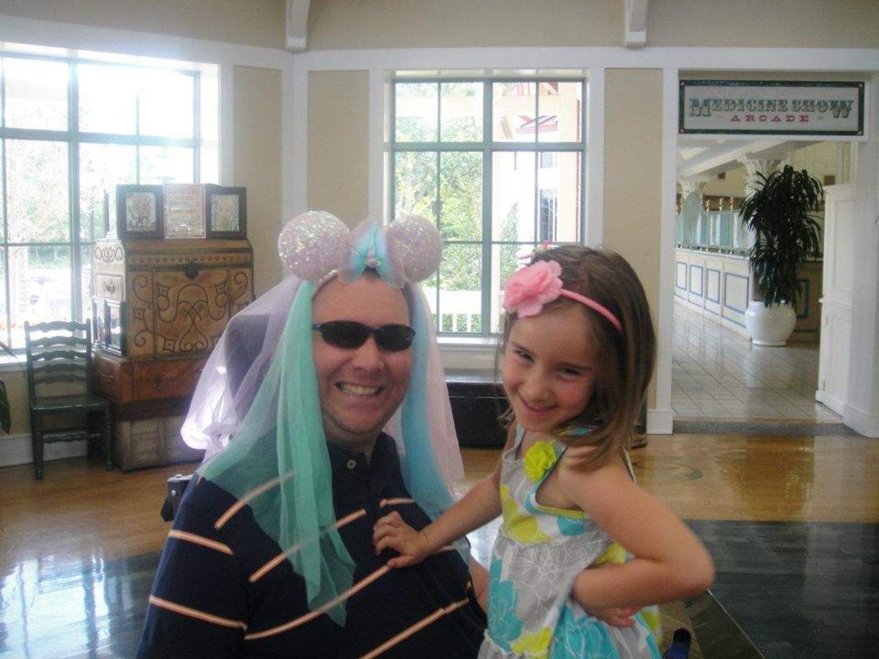 Izzy and her dad smile for the camera at Disney World. "She bought those ears and while we were waiting for the bus at Disney, she put them on him and asked him to pose with her," Hayes said. "She thinks it's hysterical to make him look silly so she does it at much as possible."