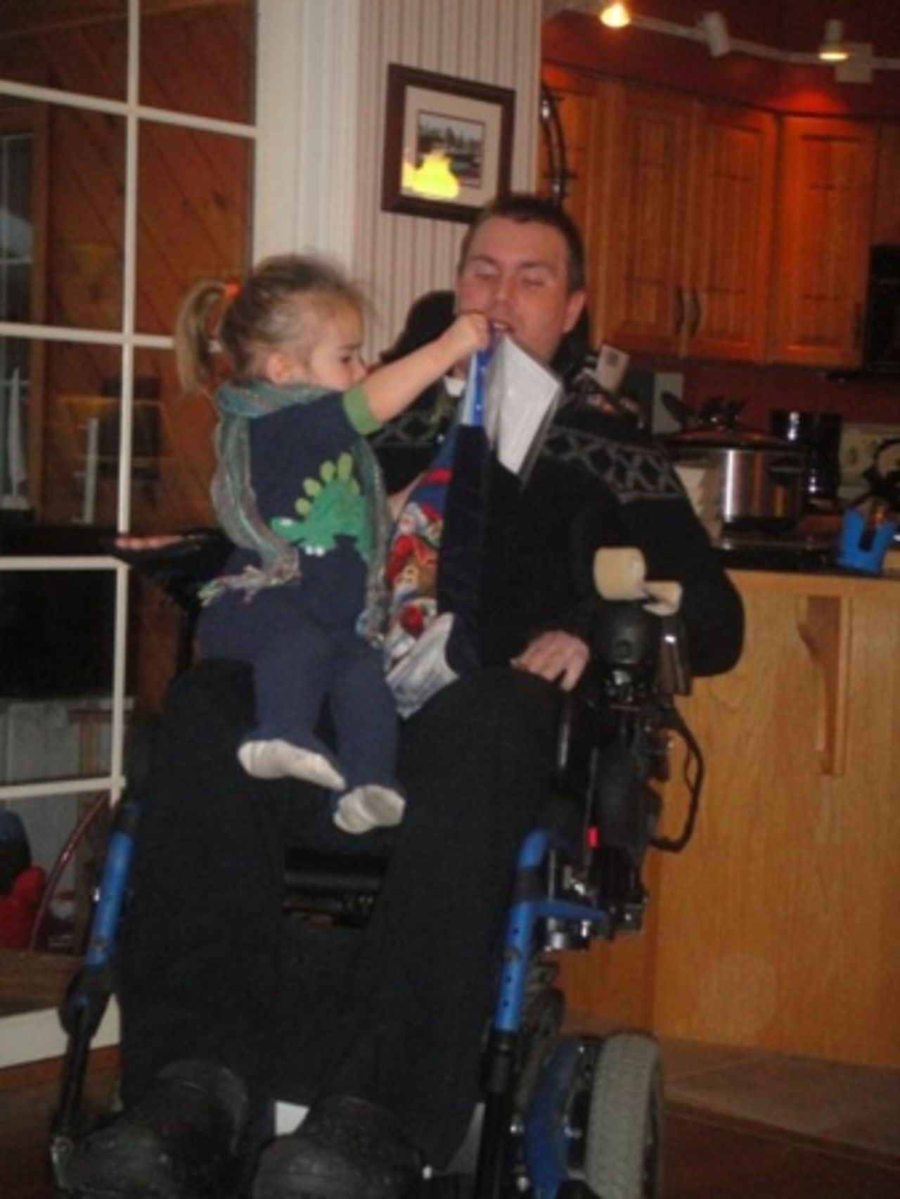 Izzy helps Ben open his stocking at Christmas in 2009, as she does every year.