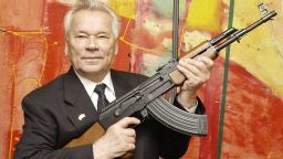 FILE - In this July 26, 2002 file photo, Russian weapon designer Mikhail Kalashnikov presents his legendary assault rifle to the media while opening the exhibition "Kalashnikov - legend and curse of a weapon" at a weapons museum in Suhl, Germany. Mikhail Kalashnikov, whose work as a weapons designer for the Soviet Union is immortalized in the name of the world's most popular firearm, has died at the age of 94, Monday Dec. 23, 2013. (AP Photo/Jens Meyer, File)