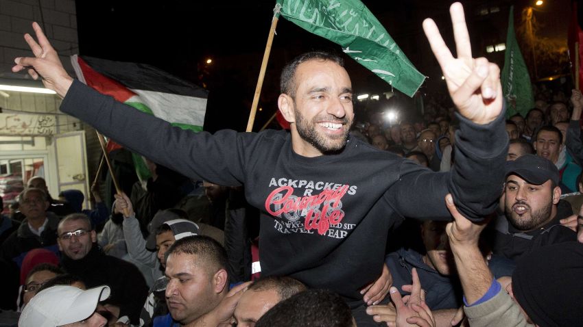 Palestinian prisoner Samer al-Issawi, who held a hunger strike for several months, flashes the "V" for victory sign as he celebrates his release from an Israeli jail in the Arab Jerusalem neighbourhood of Issawiya, on December 23 2013. AFP PHOTO/AHMAD GHARABLIAHMAD GHARABLI/AFP/Getty Images
