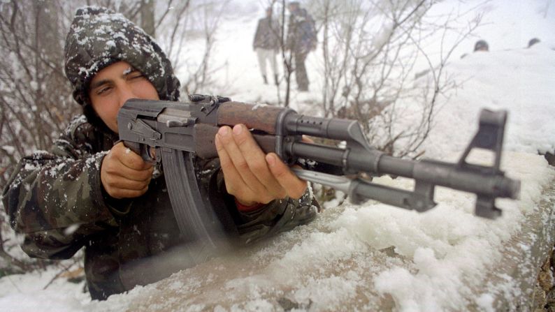 A soldier with the Liberation Army of Presevo, Medvedja and Bujanovac guards his position near the village of Shoshaj, Yugoslavia, in 2001.