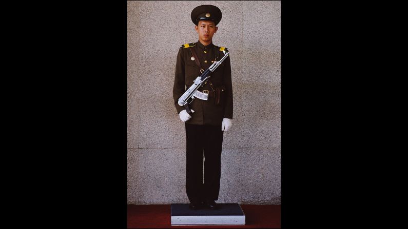 A soldier stands guard at the entrance to a sanctuary for Kim Jong Il in Myohyangsan, North Korea, in 2005.