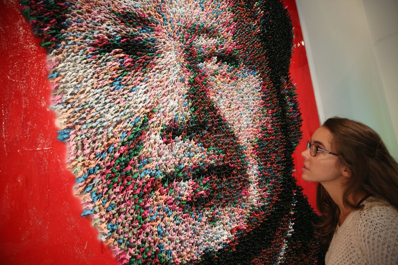  A woman admires an artwork by Joe Black of Mao Zedong entitled, 'Workers of the World, Unite!', which is made from 9000 hand-painted toy soldiers, in the Opera Gallery on October 14.