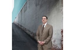 Embattled but resilient Mayor Vince Gray stands outside a charter school in Northeast Washington. - (Charles Ommanney for CNN)
