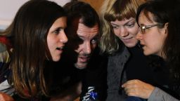 Greenpeace activists, members of the 'Arctic 30,' (from L) Camila Speziale from Argentina, Phil Ball of United Kingdom and Sini Saarela from Finland, attend an informal meeting with local residents in Russia's second city of St. Petersburg, on December 23, 2013.