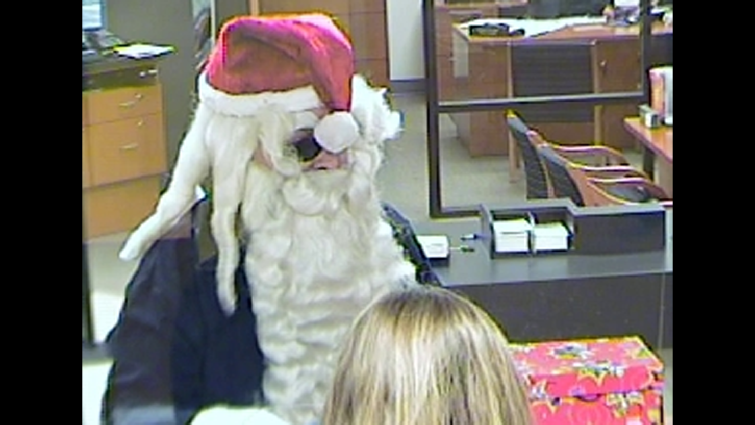 A bank robber wearing a Santa hat and beard is seen on video surveillance at a SunTrust Bank in Port Orange, Florida, on Monday, December 23.