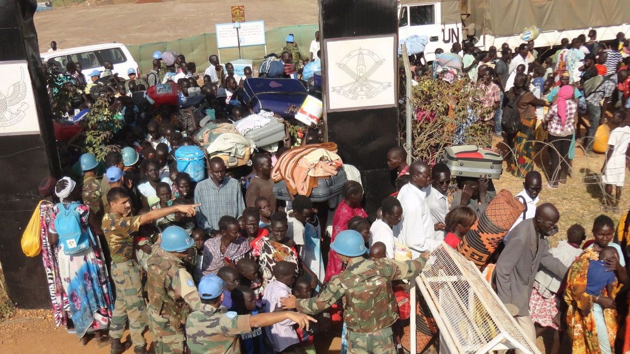A handout photo released by UNMISS on December 20, 2013 shows civilians gathering outside the UNMISS compound in Juba, on December 16, 2013. South Sudan's fugitive former vice president denied on December 18 accusations he led a coup bid against his archrival President Salva Kiir after days of fierce fighting that has killed hundreds of people and sent thousands fleeing to UN bases. Three Indian peacekeepers were killed on December 19, 2013 in an attack on a UN base in South Sudan, as fighting between rebels and government forces increased fears the world's youngest state was sliding towards civil war. AFP PHOTO / UNMISSHO/AFP/Getty Images