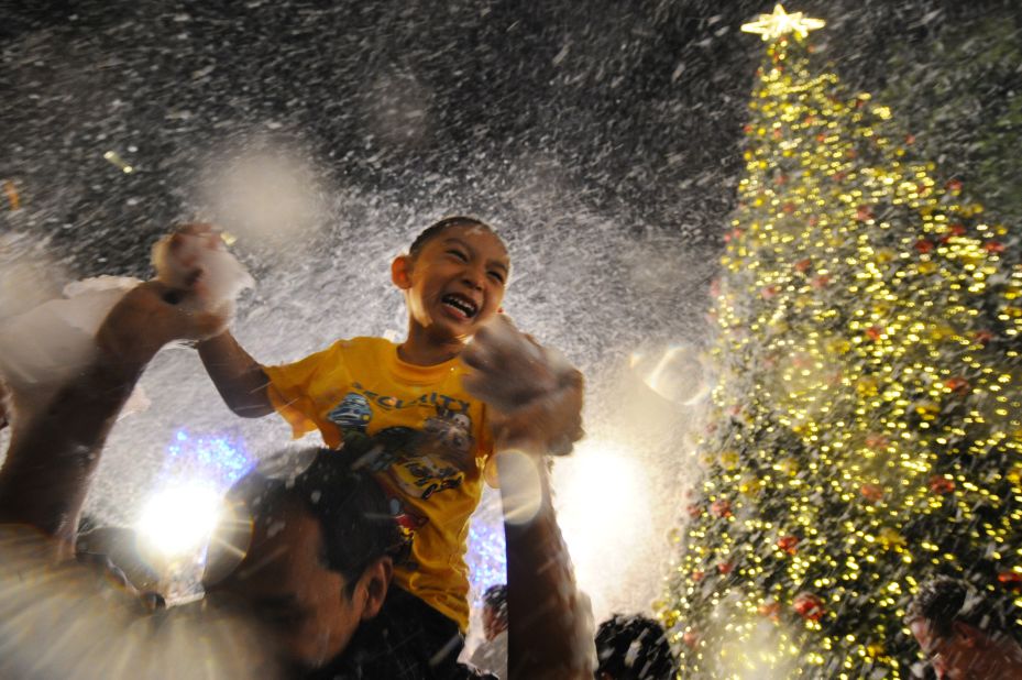 A child enjoys artificial snow at a shopping mall in Singapore on Tuesday, December 24. 