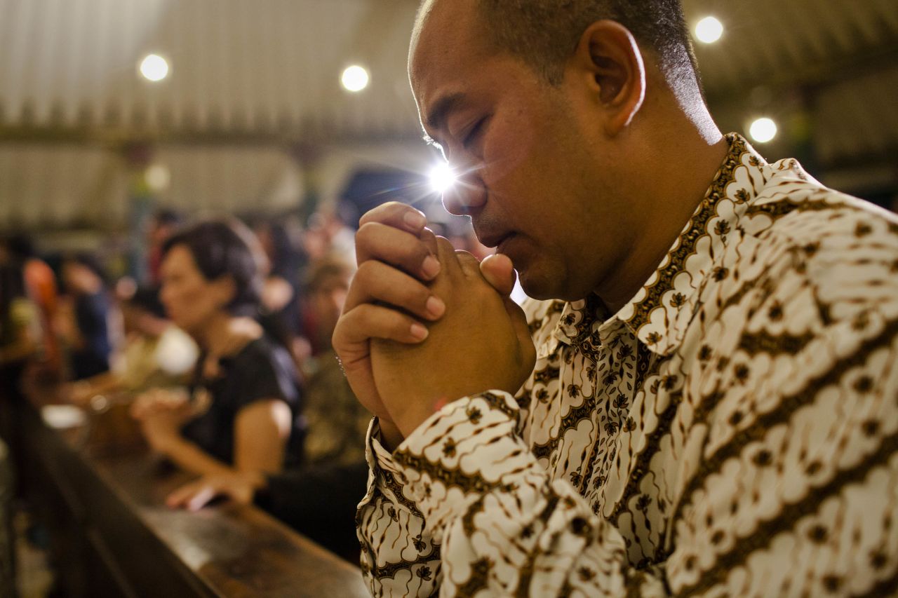 An Indonesian Javanese Christian prays during Christmas Eve Mass in Yogyakarta, Indonesia, on December 24.