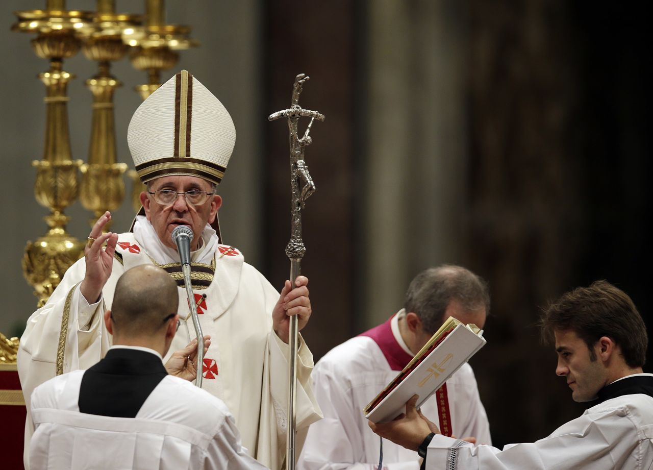 Pope Francis delivers a blessing at the end of the Christmas Eve Mass in St. Peter's Basilica at the Vatican on Tuesday, December 24. The Pope rang in his first Christmas at the Vatican with a Christmas Eve Mass preaching a message of love and forgiveness.