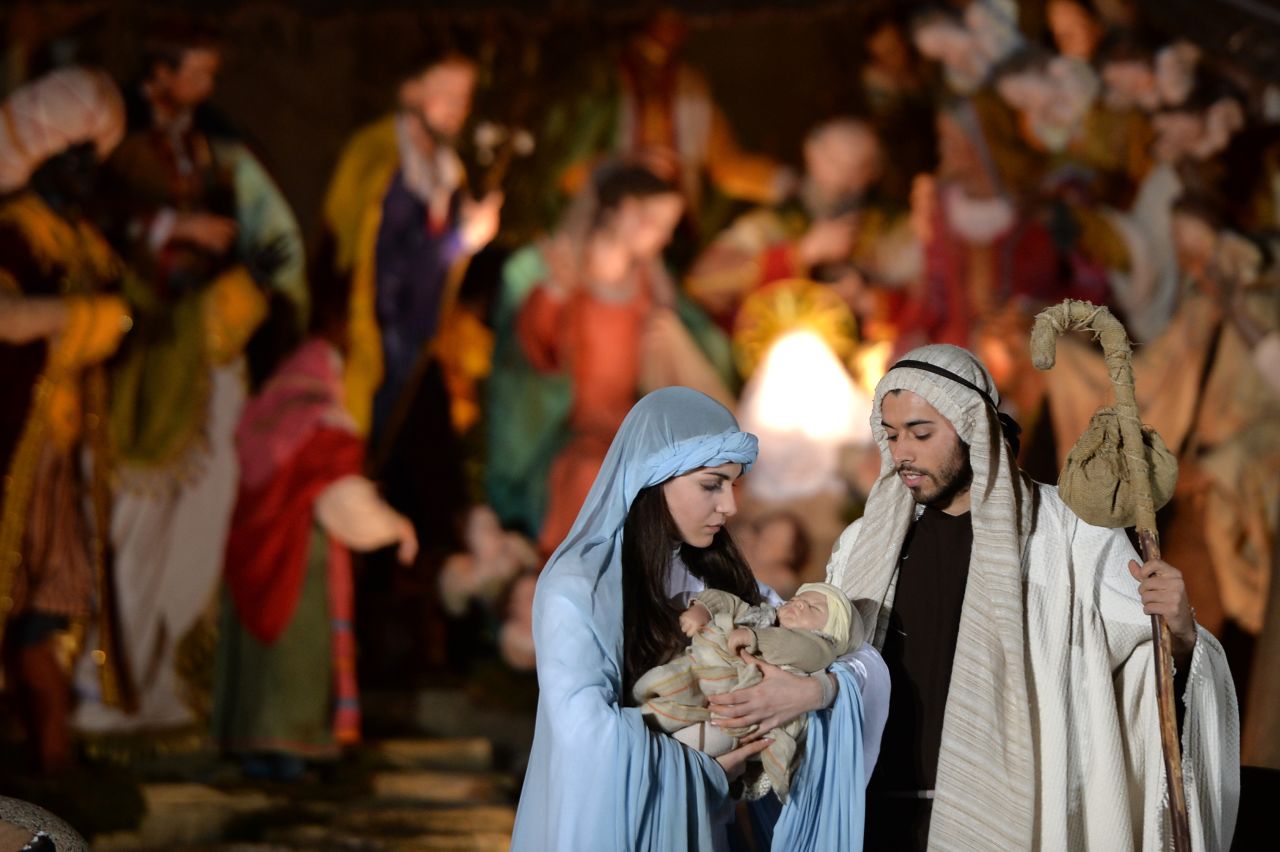 People act out a nativity scene during the unveiling ceremony of the crib in St. Peter's Square at the Vatican on December 24.
