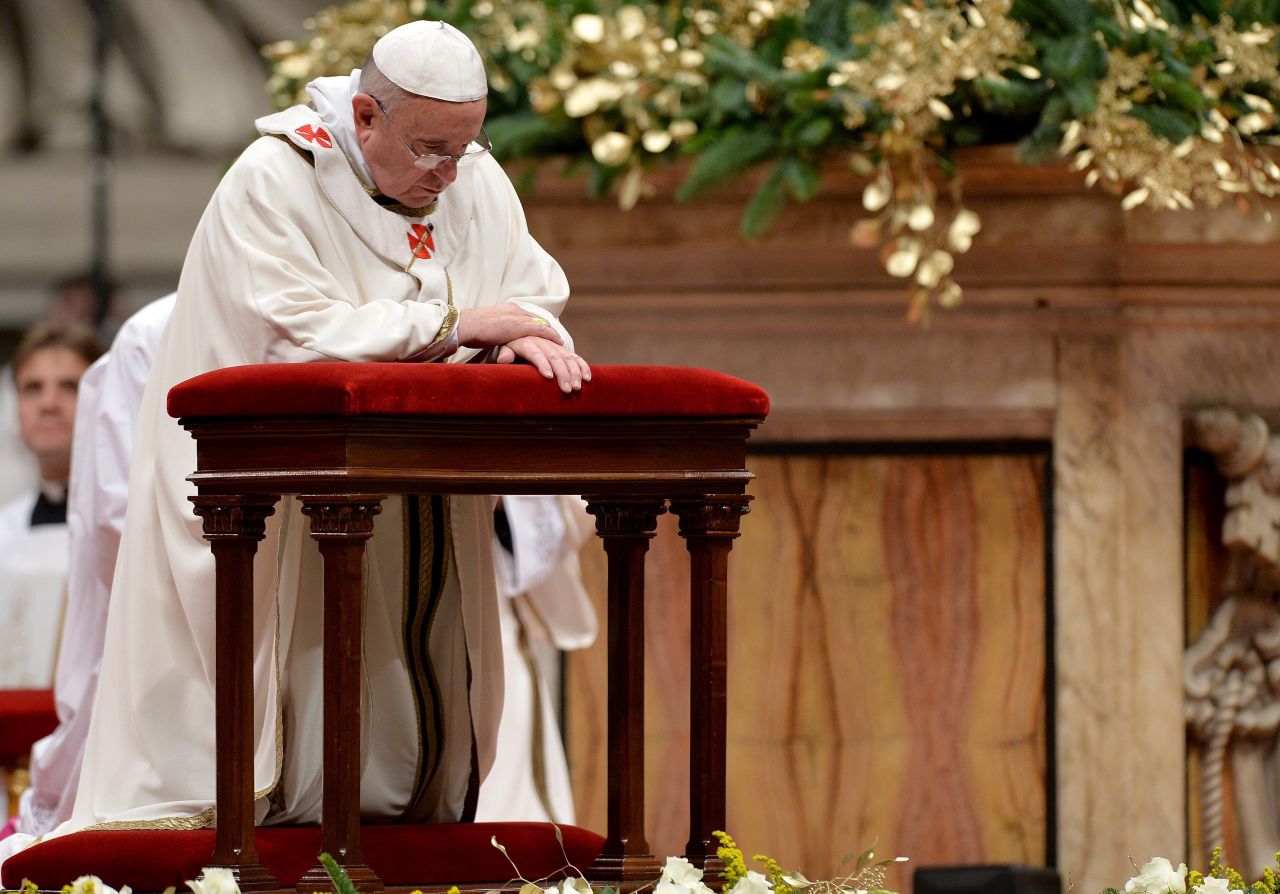The Pope prays during the service. The festivities began on Saturday, with the Pope's Christmas message to the Curia. He urged the church's governing body to avoid gossip and to focus on service.