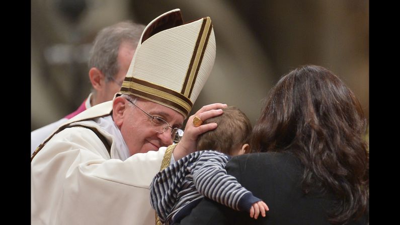 Pope Francis greets a child during the service. Before the Mass, pilgrims gathering in Vatican City told CNN they were excited to celebrate with the Pope.