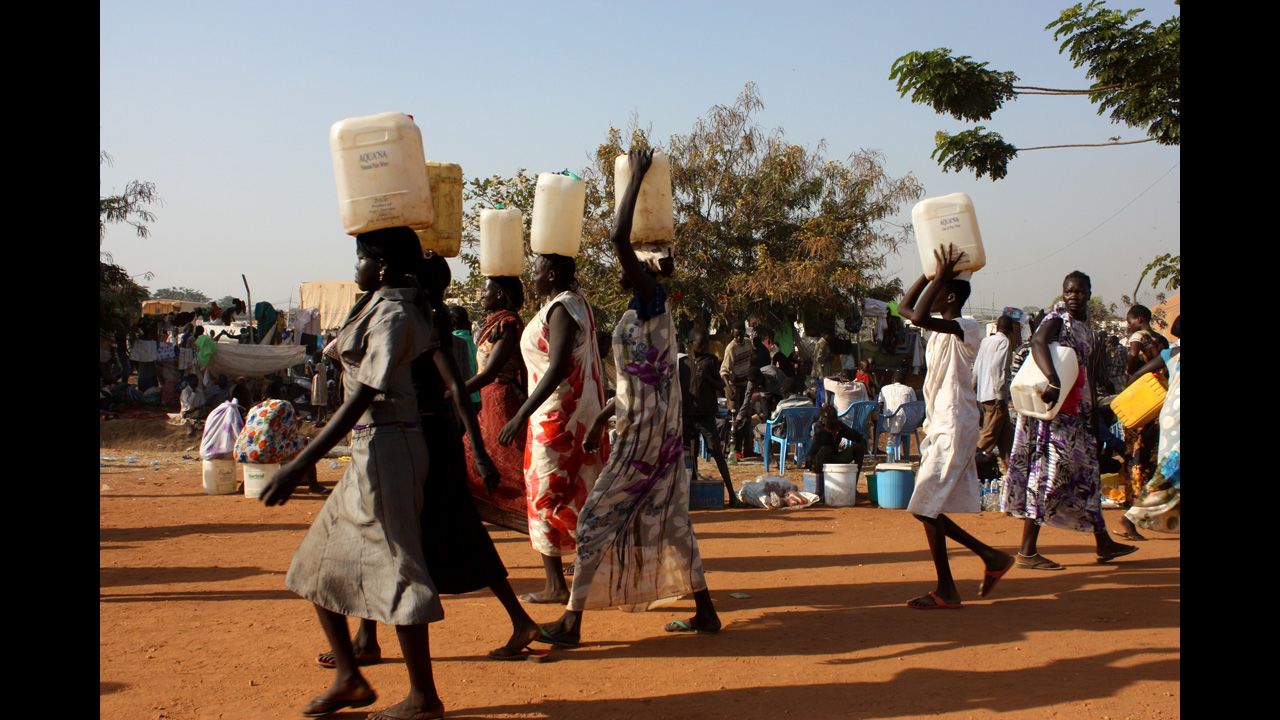 South Sudanese women carry water at a U.N. camp in Juba on December 22. 