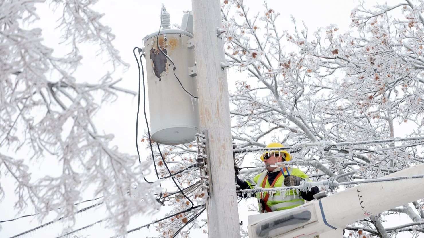 Dave Dora, with Grand Haven Board of Light and Power, works on fallen wires in Lansing, Michigan. on December 23, 2013.  