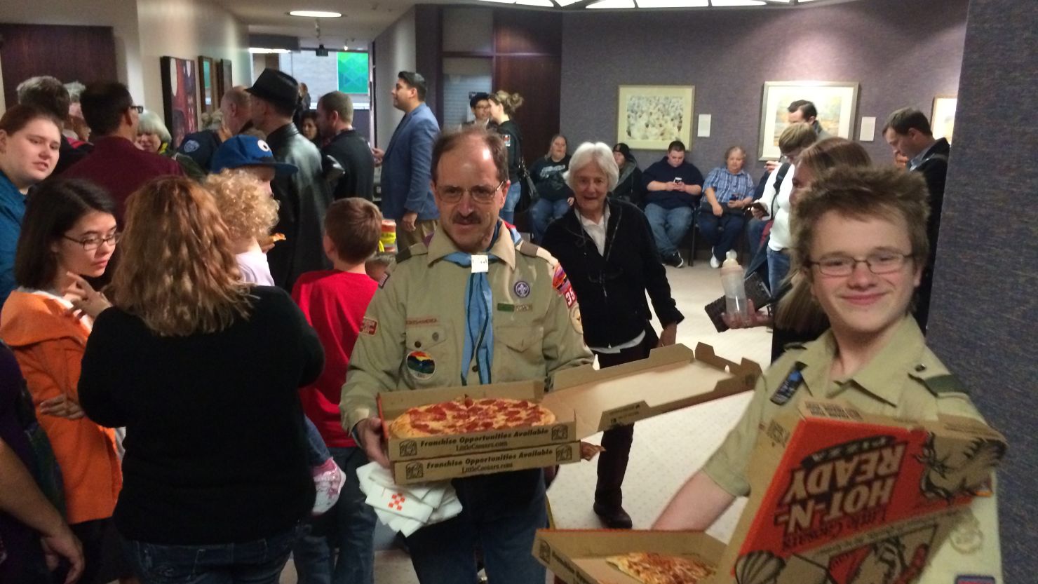 Peter Brownstein and his son deliver pizzas at the county clerk's office in Salt Lake City. He later wore a rainbow kerchief.
