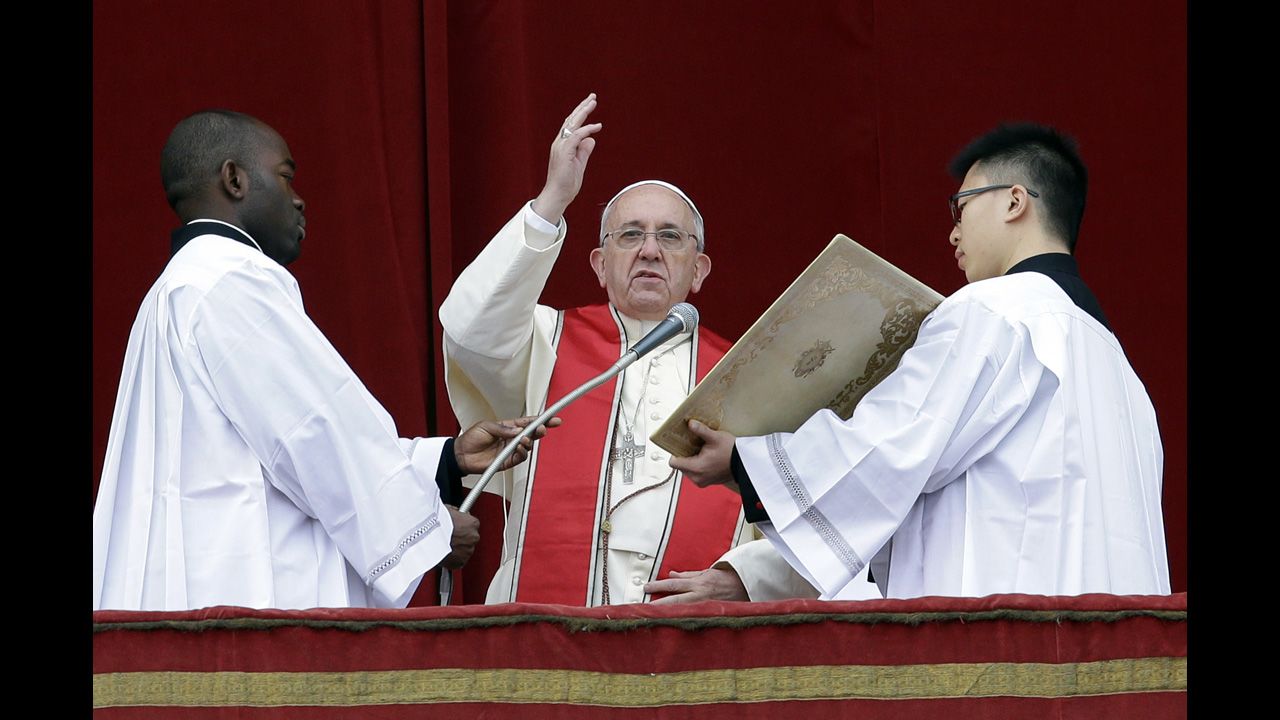 Pope Francis delivers his Urbi et Orbi, or "to the city and to the world," message from the central balcony of St. Peter's Basilica at the Vatican on Wednesday, December 25. Francis spoke to tens of thousands of tourists, pilgrims and Romans in the square below. He said he was joining in the song of Christmas angels with all those hoping "for a better world," and with those who "care for others, humbly."