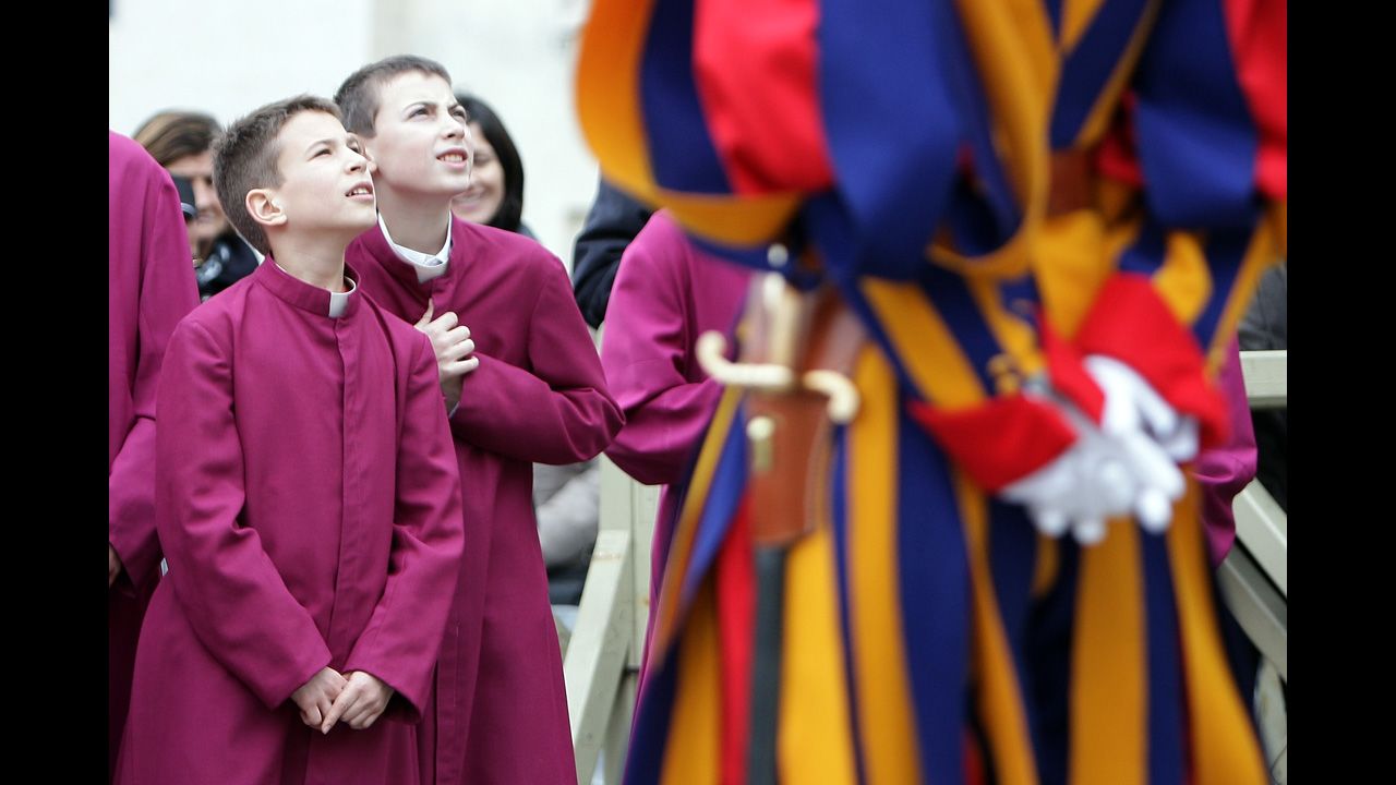 Altar boys in St. Peter's Square attend the Pope's Christmas Day message. The Pope said he is wishing for a better world, with peace for the land of Jesus' birth, for Syria and Africa as well as for the dignity of migrants and refugees fleeing misery and conflict.