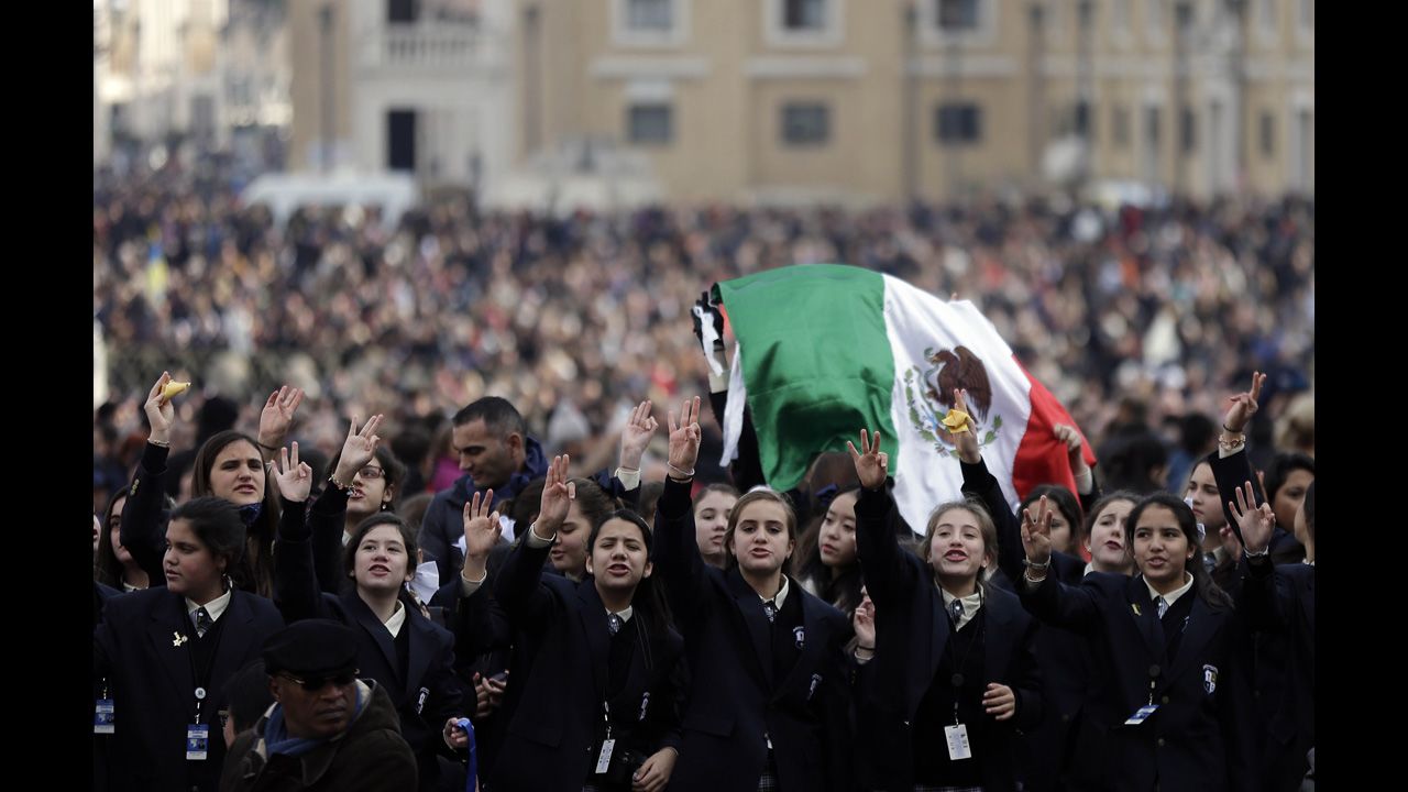 Faithful cheer before the Pope's message. Vatican TV estimated 150,000 attended the blessing in St. Peter's Square, which marked Francis' first Christmas celebration as pope.