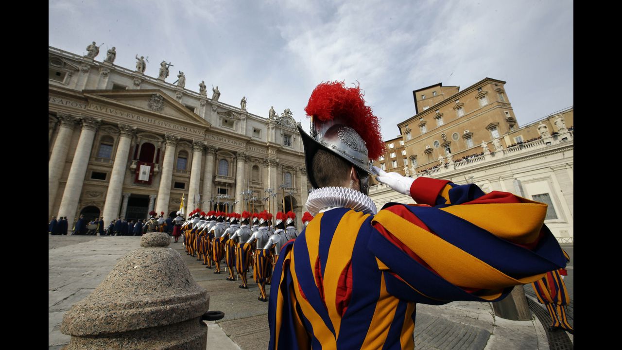 Swiss guards march prior to the start of the Pope's message.
