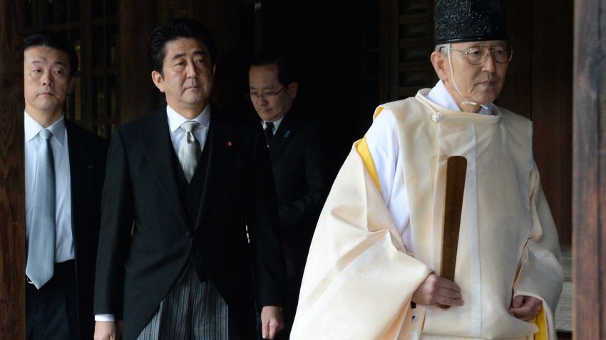 A Shinto priest (R) leads Japanese Prime Minister Shinzo Abe (C) as he visits the controversial Yasukuni war shrine in Tokyo on December 26, 2013, in a move Beijing condemned as 'absolutely unacceptable'. Abe described his visit, which is certain to roil already-troubled ties in East Asia, as a pledge against war and said it was not aimed at hurting feelings in China or South Korea. AFP PHOTO/Toru YAMANAKA (Photo credit should read TORU YAMANAKA/AFP/Getty Images)