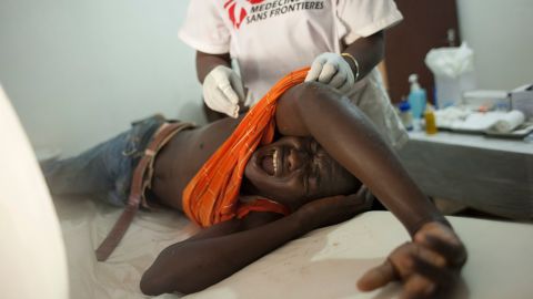 A young man who was hit in the back by a stray bullet cries out in pain at a Doctors Without Borders clinic in Bangui on Wednesday, December 25. 
