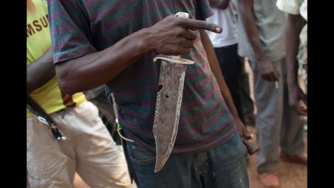 A militiaman holds a knife as he describes a recent attack in Bangui on Tuesday, December 24.