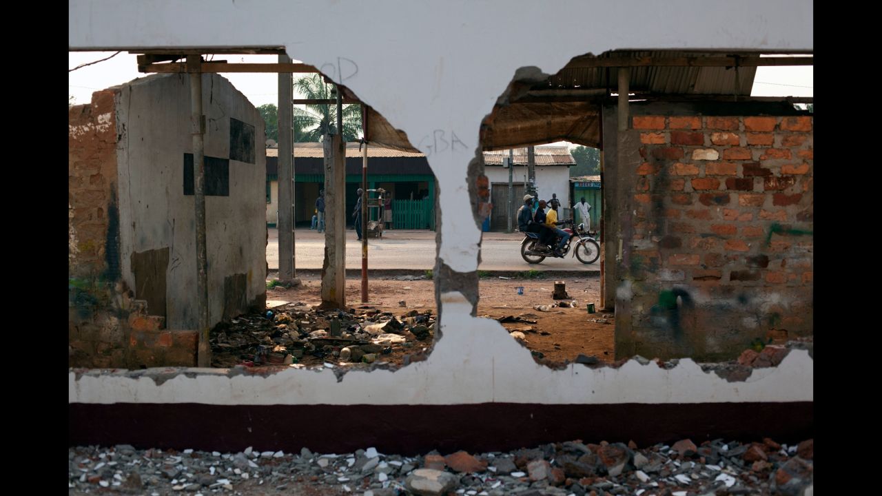 A motorcycle passes the remains of a mosque that was destroyed in Bangui in December.