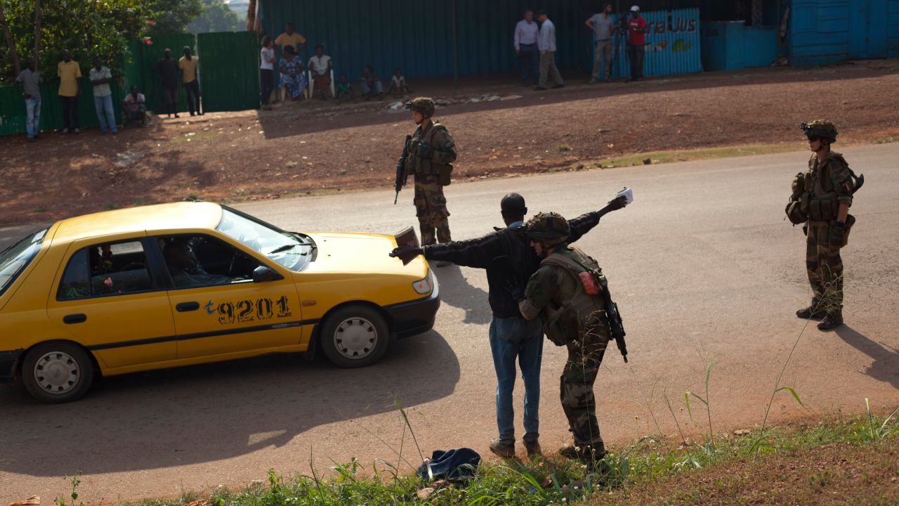 French soldiers frisk a man at a checkpoint in Bangui on December 23.