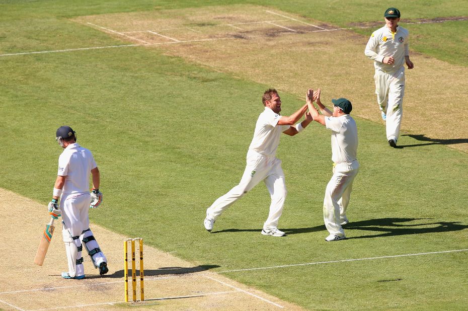 Johnson wasn't the lone Australia bowler to excel. Ryan Harris took two wickets, too. He celebrates with teammate David Warner, far right, after ousting Ian Bell.  