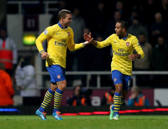 A double from Theo Walcott and a third from the returning Lukas Podolski helped Arsenal to a 3-1 win at struggling West Ham to go back to the top of the EPL.