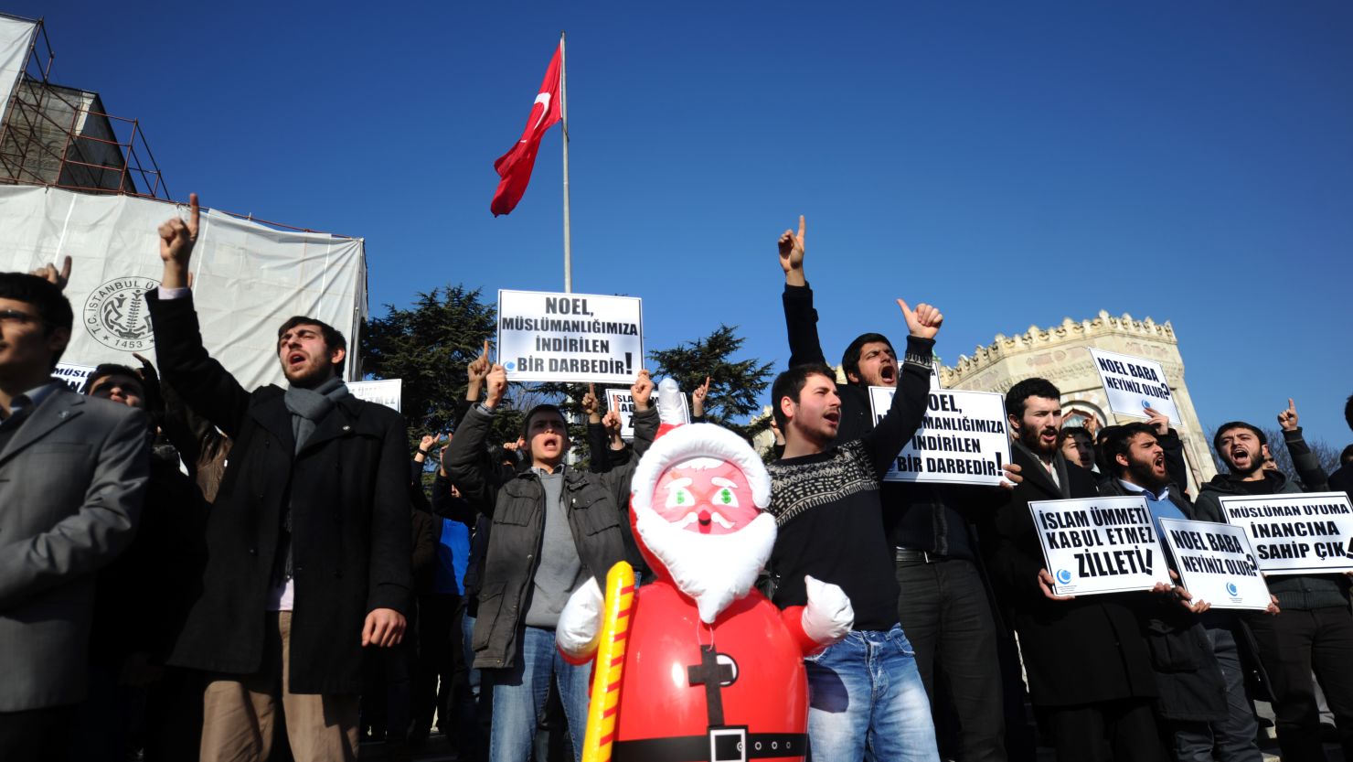 A Turkish Muslim group protests and hold signs reading 'Christmas is incompatible with Islam' during a demonstration in Istanbul on December 26.