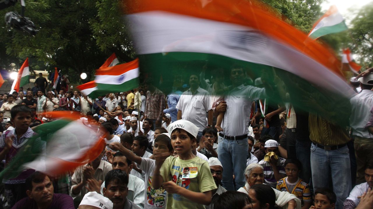 A boy waves the Indian flag during a hunger strike against corruption in New Delhi, India in 2012.