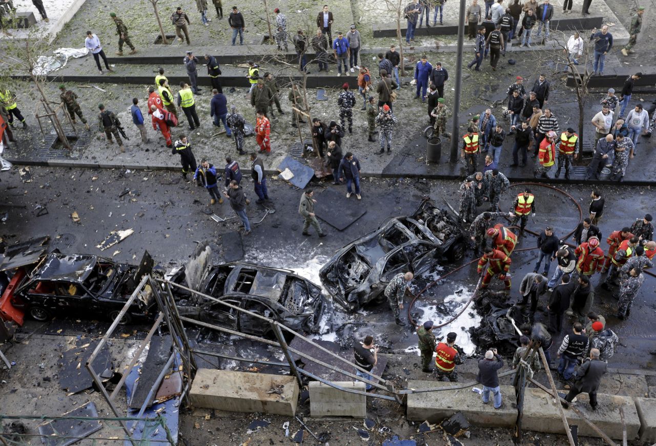 Lebanese security forces and firefighters gather next to destroyed vehicles. No one has claimed responsibility for the attack.