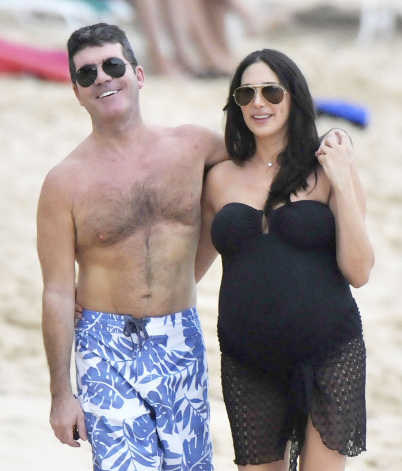 Simon Cowell and his pregnant girlfriend, Lauren Silverman, were all smiles at the beach in Barbados on December 26.