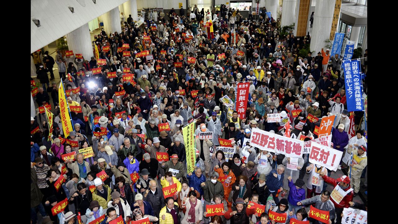 Hundreds of protesters stage a rally opposing the approval of the relocation in the lobby of Okinawa prefecture's government building in Naha on Friday, December 27. The Futenma air base, which is in a highly populated area, has been unpopular with the island's residents because of crimes committed by U.S. military personnel and allegations against them in the past.