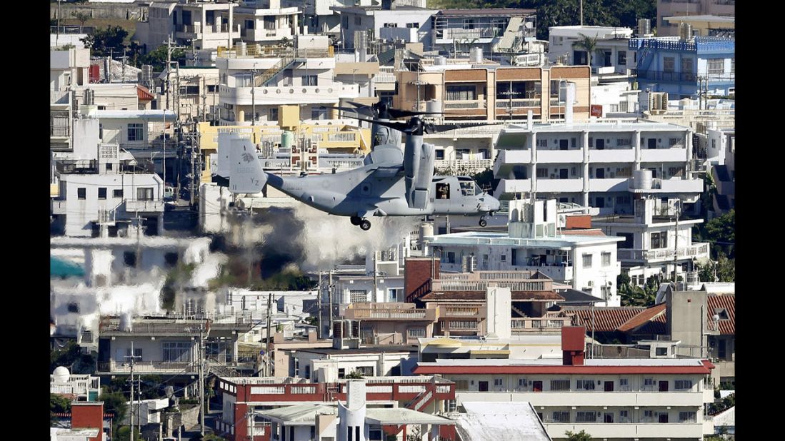 An Osprey tilt-rotor aircraft flies over Ginowan on August 3, heading for the Futenma Air Station for additional deployment. The stagnation of the relocation issue has been a thorn in the side of relations between Tokyo and Washington since 1996, when the two governments agreed on the original plan to move the base.