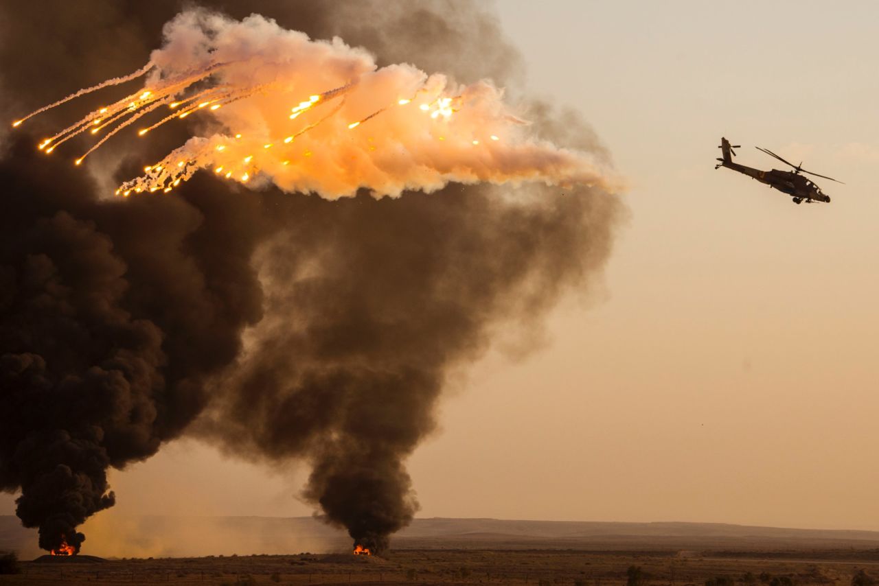 DECEMBER 27 - NEGEV DESERT, ISRAEL: An Israeli AH-64 Apache Longbow helicopter launches anti-missile flares during an air show at the graduation ceremony of Israeli air force pilots at the Hatzerim base, near the southern Israeli city of Beer Sheva on December 26.