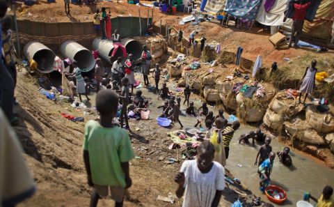 Displaced people bathe and wash clothes in a stream in a U.N. compound in Juba on December 27.