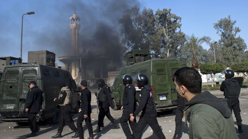 Egyptian riot policemen surround the entrance of al-Azhar university during clashes with students who support the Muslim Brotherhood, in Cairo's eastern Nasr City district on December 27, 2013. At least 148 pro-Islamist protesters were arrested after they rallied in several Egyptian cities, police said, as the authorities vowed to repress demonstrations by the Muslim Brotherhood. AFP PHOTO / KHALED DESOUKIKHALED DESOUKI/AFP/Getty Images