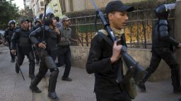 Egyptian riot policemen run after Muslim brotherhood members following a demonstration in Cairo's eastern Nasr City district on December 27, 2013.
